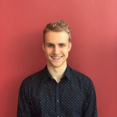 Jack Gralla red wall headshot Jack Gralla red wall headshot